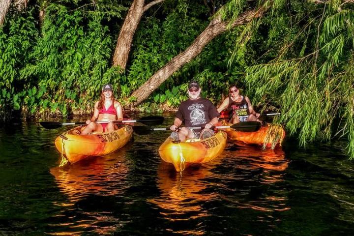 people in kayaks at night