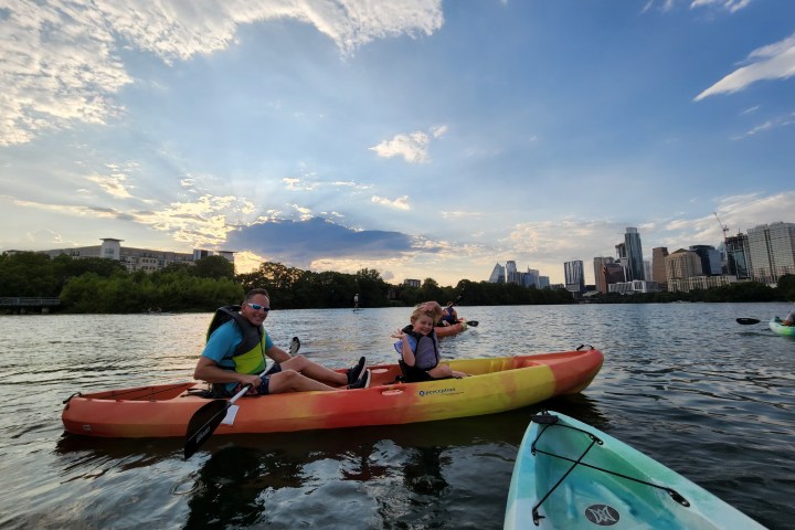 a group of people in a small boat in a body of water